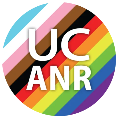 UC ANR in a circle with light blue, white, pink, brown, black, red, orange, yellow, green, royal blue and purple stripes.