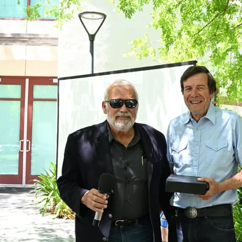 UC Davis distinguished emeritus professor Frank Zalom (right) pays tribute to UC Davis distinguished professor James R. Carey. (Photo by Kathy Keatley Garvey)