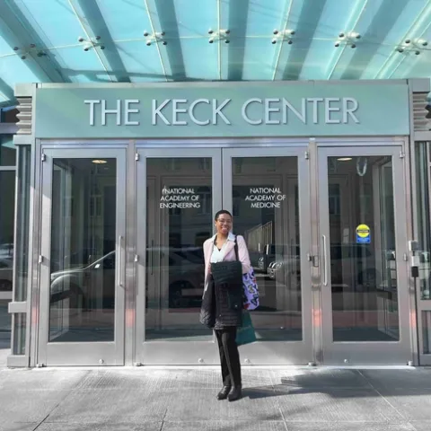 Eve at doorway to the Keck Center