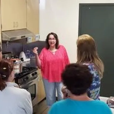 training class, students in a commercial kitchen listening to the instructor