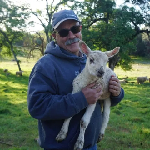 Dan Macon holding a lamb.