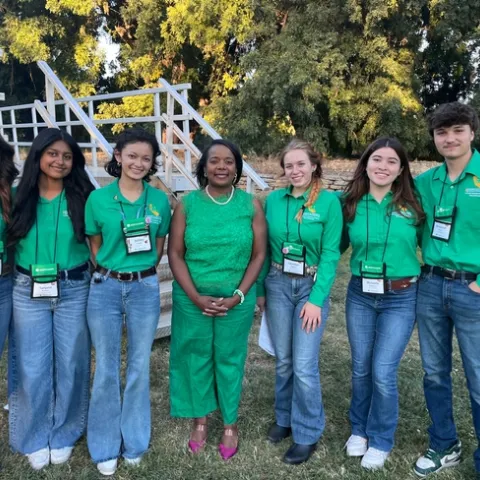 Kim Holmes, center, poses with the 2023-24 4-H State Ambassador team at the State Leadership Conference Kickoff event