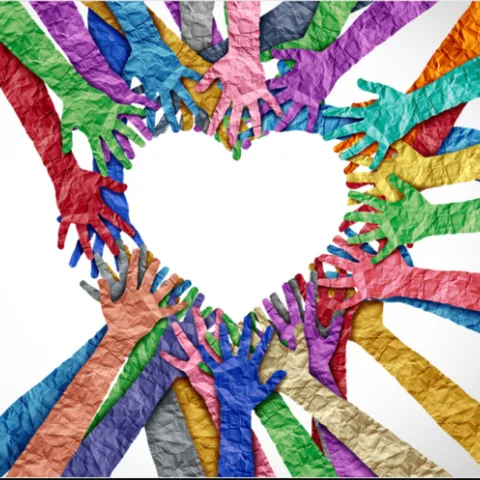 rainbow of colored hands made out of paper linking together to create a heart
