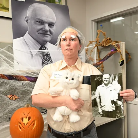 Tabatha Yang, education and outreach coordinator of the Bohart Museum of Entomology, strikes a pose as "Doc" Bohart at the Bohart Museum Society's Halloween party. (Photo by Kathy Keatley Garvey)