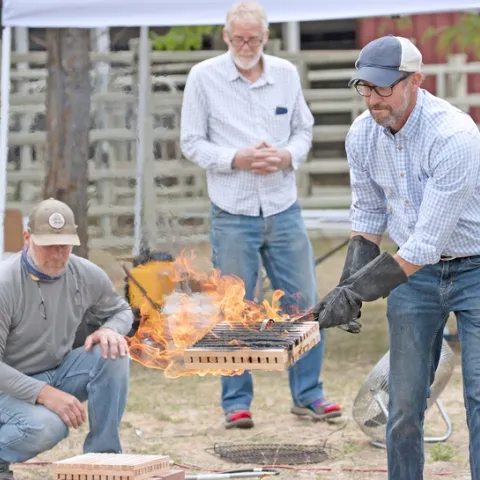 Ryan Tompkins, right, demonstrates wildfire risks. He will be posthumously honored by the state Board of Forestry on Nov. 6.