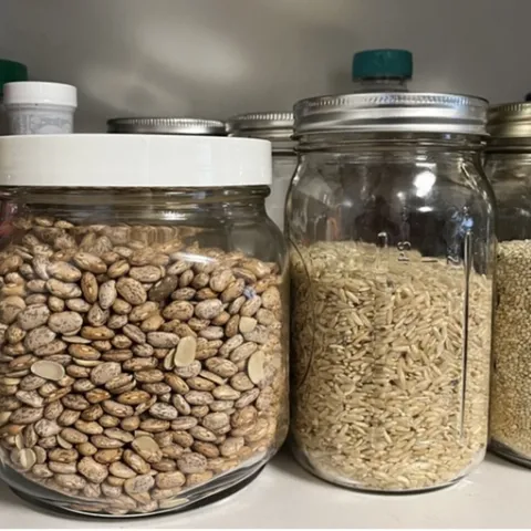 Various grains stored in glass jars.