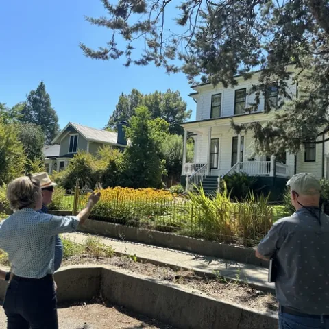 A UCCE advisor points out home hardening features on a house