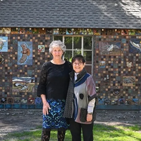 UC Davis distinguished professor emerita Diane Ullman (left) and Gale Okumura, lecturer emerita, Department of Design, stand in front of their project, "A Bird's Eye View," at the California Raptor Center. (Photo by Kathy Keatley Garvey)