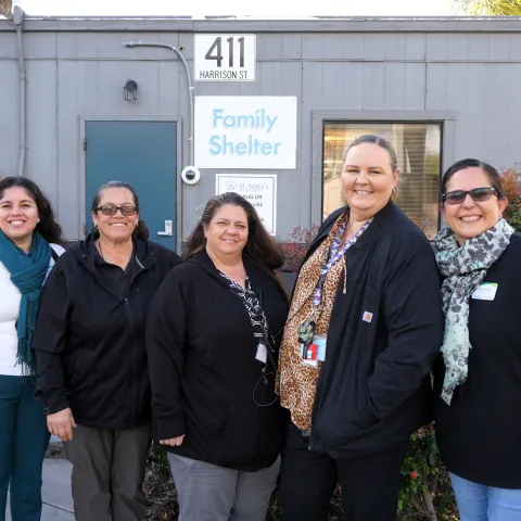 Calfresh Healthy Living, UC Cooperative Extension educators stand next to partners at St. Mary's Community Services in front of the family lodge in Stockton