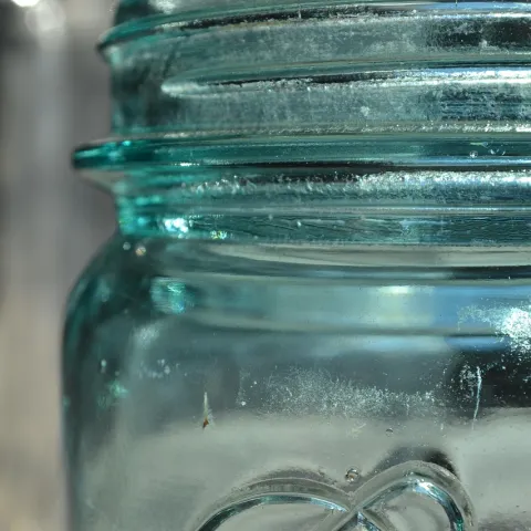 edge of a blue Ball canning jar
