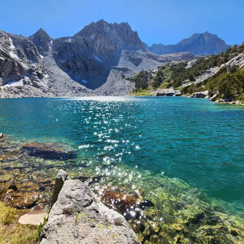 Turquoise blue water shimmers in lake