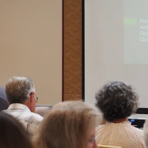 Person lecturing in front of a group of people
