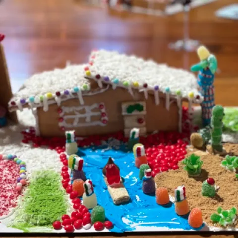 Gingerbread house with candy plants, skating rink and outhouse