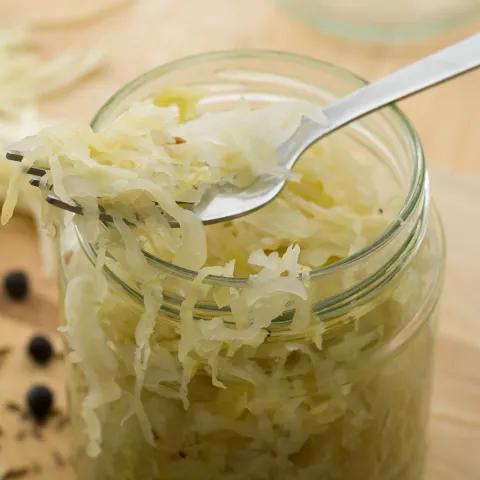 close up of an open jar of prepared sauerkraut