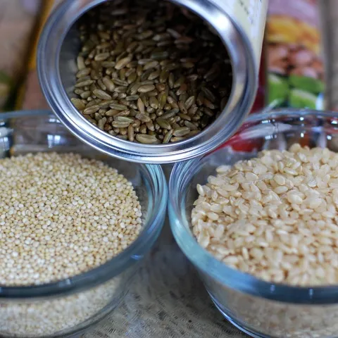 three small containers with uncooked grains