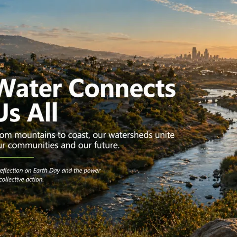 Aerial view of a Southern California watershed at sunset, showing a river flowing through urban neighborhoods toward the coastline, illustrating the connection between communities and natural water systems.