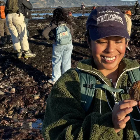 Daisy Prado holds a shell as she explores Duxbury Reef as part of a UC California Naturalist course excursion
