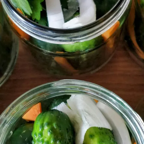 Pickles in a jar looking down from above