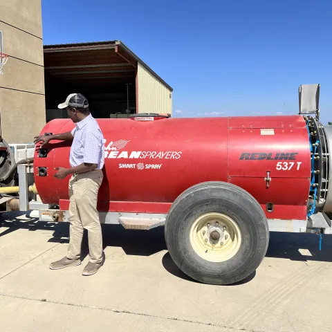 Peter points to a red spray rig