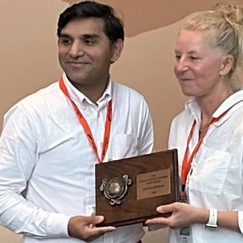 UC Davis nematology professor Shahid Siddique receives the Excellence in Teaching Award, Society of Nematologists, from the Dorota Porazinska, associate professor at the University of Florida and chair of the SON Awards Committee.
