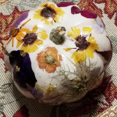 white pumpkin decorated with pressed flowers