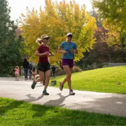 Students running on a trail at the Arboretum