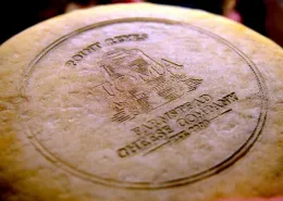 A finished wheel of Toma cheese in the aging room at the Point. Reyes Farmstead Cheese Company