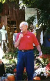 Bob Knoerschield addresses farm tour participants in front of the farm's Halloween-accessorized retail shop.