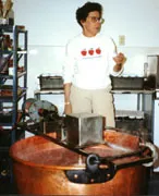 Ellen Knoerschield explains the apple butter process that begins with this vat in her shed.