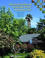 Cover of the book "Abiotic Disorders of Landscape Plants" featuring a lush green landscape, a wooden structure, and a tall palm tree, with vibrant flowers in the foreground.