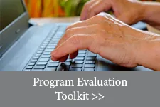 hands typing on a keyboard. Text overlay reads: Program evaluation