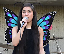 Molecular geneticist and vocalist Christine Tabuloc of the Joanna Chiu lab, wrapped herself in butterfly wings. (Photo by Kathy Keatley Garvey)