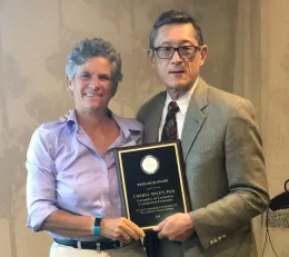 Cheryl Wilen, left, receives award from Loren Oki.