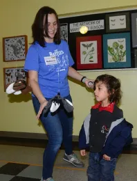 Graduate student Rebecca Godwin of the Jason Bond lab helps youngsters