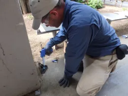 Figure 4. Cockroach bait was applied within lock-and-key mouse bait stations (Protecta RTU). Bait was also applied within subsurface utility ports. (Credit: Casey Hubble-Wirgler)