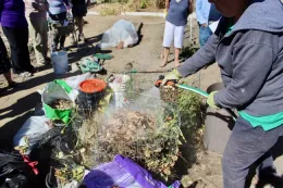 Watering the prepared compost pile