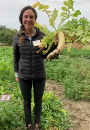Alli Fish holding a radish.