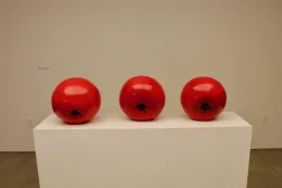 3 Tomatoes on a pedestal.