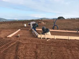 Forming for a building at climate change plots to house a boiler to heat plots.