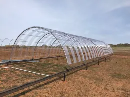 Image of poly carb attached to a rainout structure to reduce rainfall by 50%