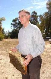 Eric Mussen holding a frame. This image is from 2007. (Photo by Kathy Keatley Garvey)