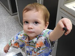 Two-year-old Chip, a budding entomologist from Woodland, shows a toy critter his mother purchased for him, along with a zippered butterfly/bug habitat, in the Bohart Museum gift shop. (Photo by Kathy Keatley Garvey)