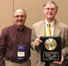 Gene Brandi (left) served as the emcee at the CSBA luncheon memorializing Eric Mussen. Here, as the 2018 president of the Foundation for the Preservation of Honey Bees, he presents the 2018 Founders' Award to Mussen.