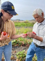 Kirsten Pearsons talks with a farmer in a field