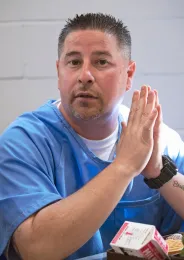 Jason Romero pauses to look up from his meal tray
