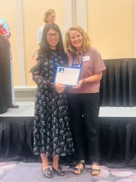 Yu Meng, receives the NEAFCS New Professional Award from Western Region President Dianne Christensen.