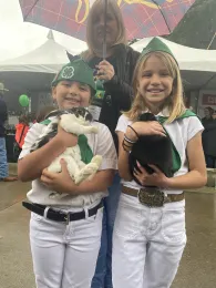 2 4-H youth holding rabbits