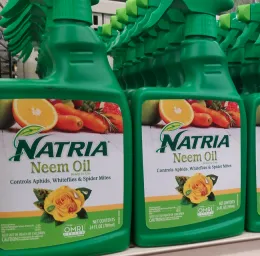 A close up of two green pesticide bottles.