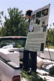 Frank Zalom stands in the bed of a pickup truck to talk to almond growers in Stanislaus County in 2001.