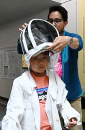 Noel Sardenia, 9, of American Canyon, tries on a beekeeping suit. (Photo by Kathy Keatley Garvey)